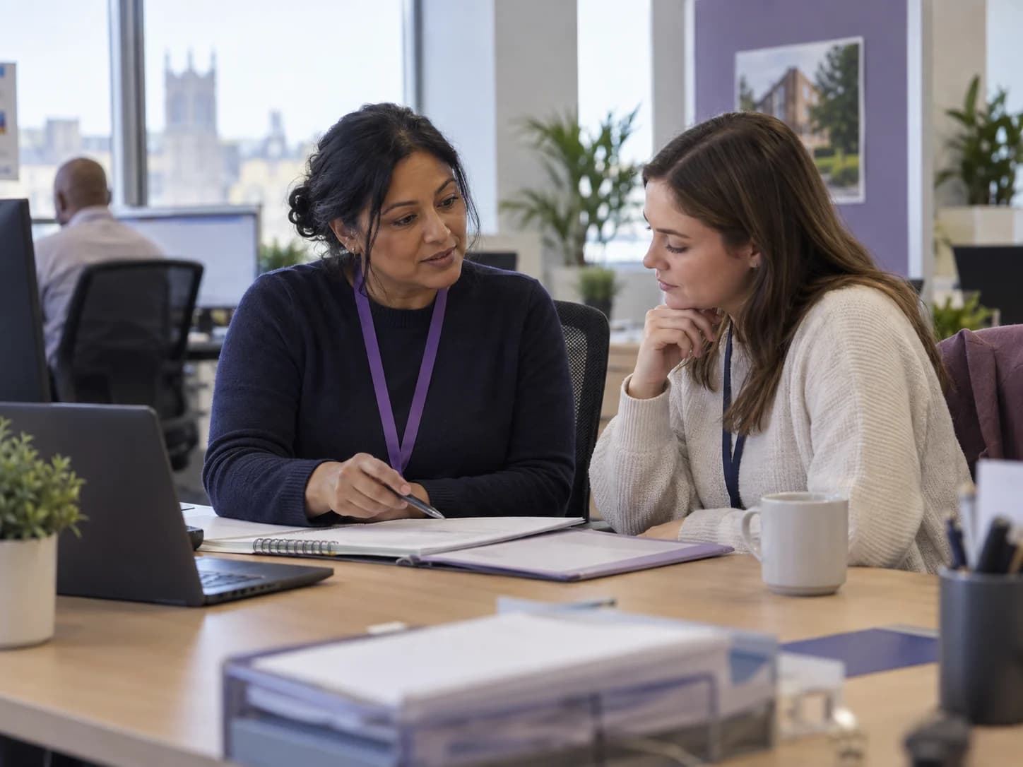 Two council housing officers reviewing a temporary accommodation placement together